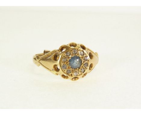 18CT GOLD, SAPPHIRE AND DIAMOND CLUSTER RING, star set with a central sapphire, with a surround of ten rough cut melee diamon