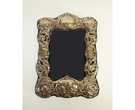 MODERN ART NOUVEAU-STYLE SILVER FRONTED PHOTOFRAME, with cherub design, London 1988, 8 ½" (21.5cm) high