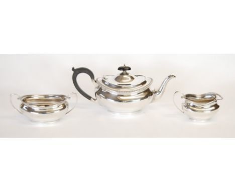A SILVER THREE PIECE GEORGIAN STYLE TEA SERVICE, by BARKER BROTHERS, with gadroon borders, black insulator handle and knop, C