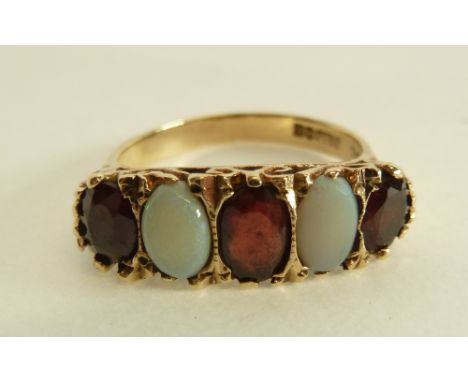 A 9ct GOLD FIVE STONE GARNET AND OPAL SET RING, hallmarked Birmingham 1973