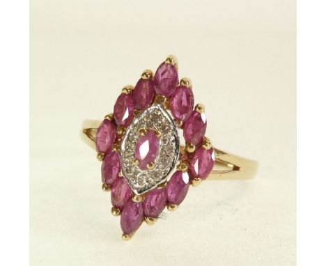 9CT GOLD RUBY AND DIAMOND RING, lozenge shaped top set with twelve marquise cut small rubies, centre set with a marquise cut 