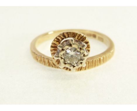9CT GOLD SOLITAIRE DIAMOND RING, illusion set, 0.10ct approx., with the textured crossover band, Birmingham 1977, 1.9g