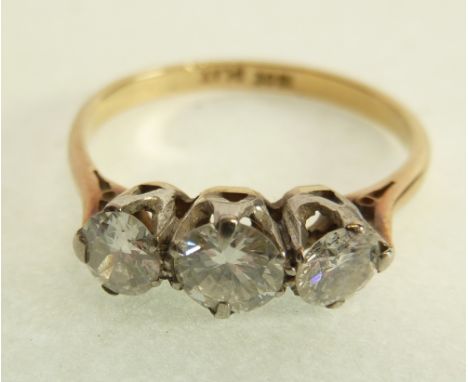 A STAMPED 18CT GOLD THREE STONE DIAMOND RING, centre stone 0.25ct approx., flanking stones each 0.18ct approx., 2g