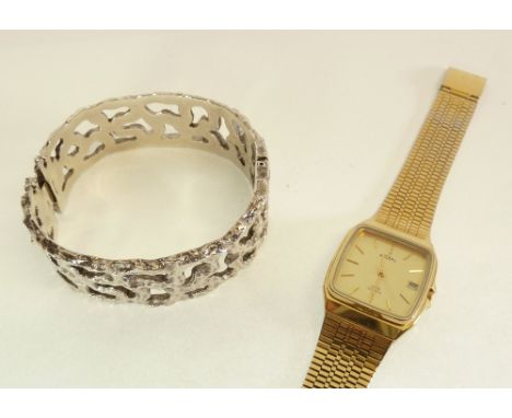 SILVER 1970s PIERCED AND TEXTURED HINGE OPENING BANGLE, London 1975, 45.7g AND A GENT'S ROTARY GILT METAL QUARTZ CALENDER WAT