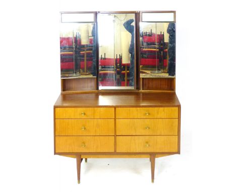 A 1960/70's teak dressing table, the three section backlit mirrors over an arrangement of six drawers on tapering feet, l. 10