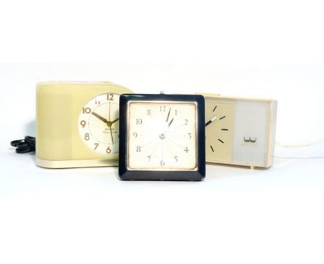 A Westclox tole bedside alarm clock, h. 13 cm, together with two other clocks