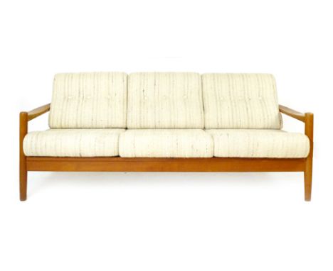 A 1970's teak framed three seater sofa with loose button upholstered cushions on circular straight legs, L.189cm, H.75cm, D.7