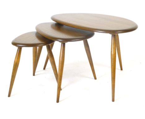 An Ercol golden dawn nest of three 'Pebble' coffee tables on circular tapering feet, max. l. 65 cm CONDITION REPORT: Structur