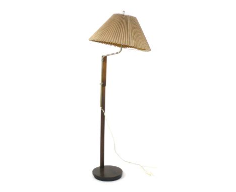 A 1970's turned beech standard lamp with a stainless steel bent and adjustable shaft on a circular base  CONDITION REPORT: Wo