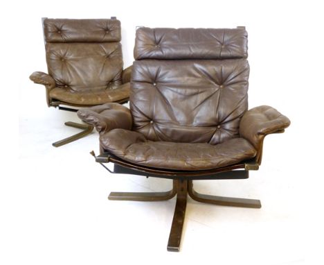 A pair of 1970's brown leather and button upholstered armchairs on formed laminate bases CONDITION REPORT: Structurally sound