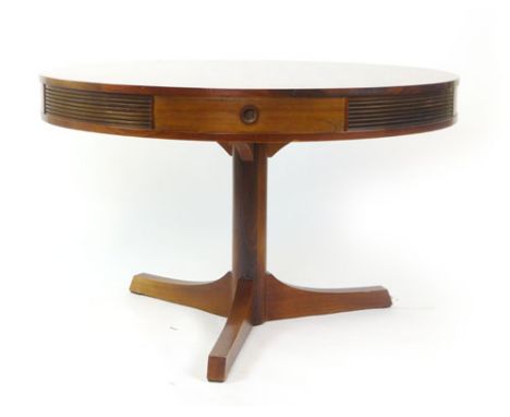 Robert Heritage for Archie Shine, a 1960's circular rosewood drum table with four frieze drawers on a tripod pillar support, 