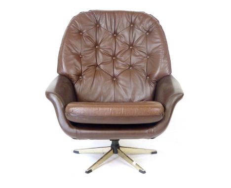 A 1970's brown vinyl and button upholstered swivel armchair on a chromed five star base CONDITION REPORT: Base heavily pitted