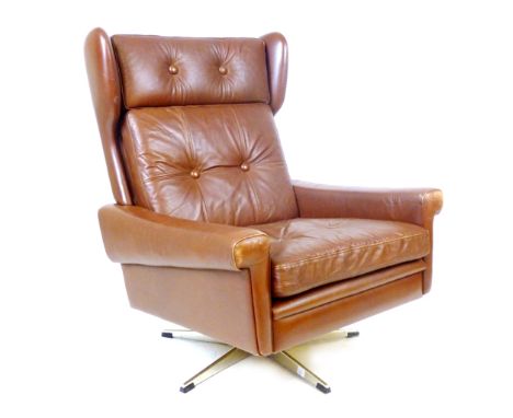 A Skippers Mobler red leather and button upholstered wingback armchair on a chromed five star swivel base CONDITION REPORT: S