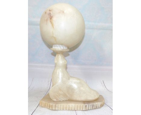 An Alabaster table lamp in the form of a seal