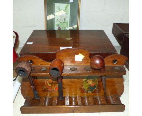 A mahogany box, a wooden pipe rack decorated with hunting scenes and pipes, a framed butterfly silk