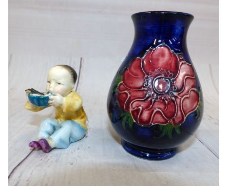 A small Moorcroft baluster vase decorated with anemones against a blue ground, a Royal Worcester figure ''China'' No. 3073