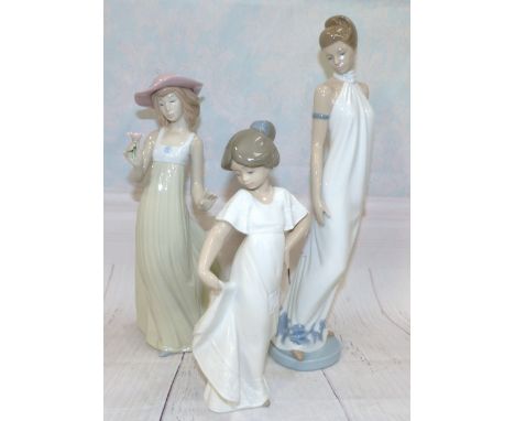 A Nao figure of a lady and two other Nao figures