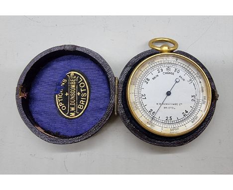 An antique gilt brass pocket barometer, the&nbsp;silvered dial inscribed 'M W Dunscombe Ltd, Bristol', in leather case. 