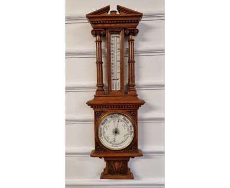 A late Victorian carved oak aneroid barometer, 92cm high. 