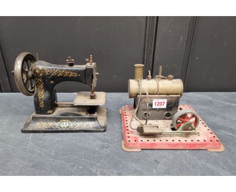 A stationary steam engine,&nbsp;21cm wide; together with an antique American child's sewing machine. (2) 