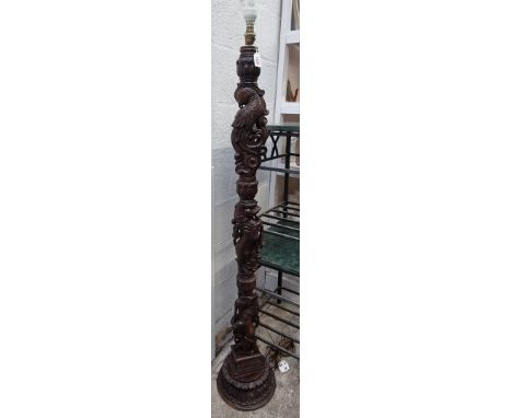 An Eastern carved hardwood standard lamp,&nbsp;decorated with animals, height excluding fitting 143cm. 