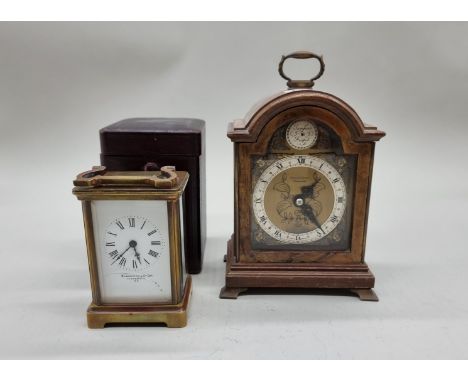 A small 1930s walnut mantel clock,&nbsp;by Elliott, 21cm high; together with&nbsp;a brass carriage timepiece, in leather trav