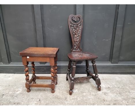 A 1920s carved oak spinning stool; together with another 1920s oak table, 38cm wide. (2) 