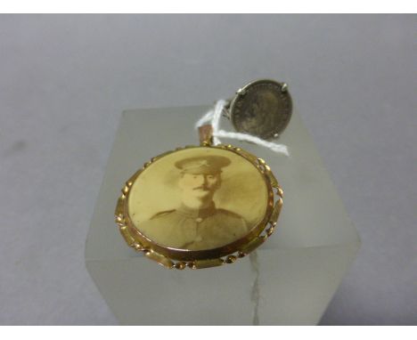 A Silver Ring Set with a Silver George V Coin plus a World War I Yellow Metal Portrait Pendant 
