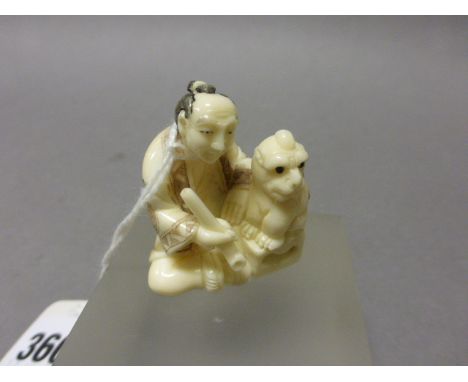 An Ivory Netsuke Man with Dog 