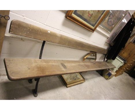 An Antique Elm Bench with wrought iron legs and supports 