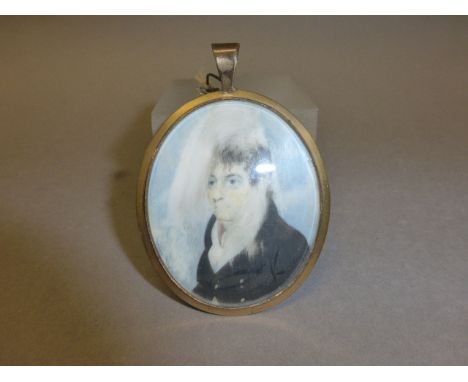 A 19th century Oval Miniature Gilt Framed Half Length Portrait of a Gentleman in Ivory, the reverse set with hair 