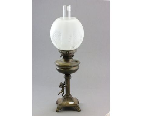 An Antique Brass Oil Lamp with classical cherub design 