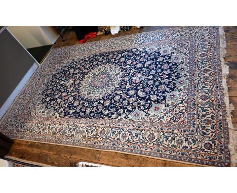 A classic Persian Nain carpet, the camel field centred by a blue floral medallion, 204 cm&nbsp; x 310 cm