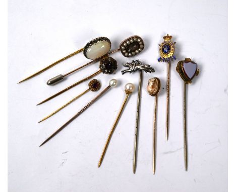 A collection of ten various stickpins - seed pearls enclosing hairwork, 1897 Carabiners enamelled, foil backed paste and amet