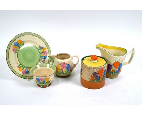 A Clarice Cliff Crocus pattern small cream jug, sugar basin and tea plate to/w a milk jug and a preserve jar and cover (5)Two