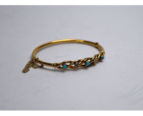 An antique oval half-hinged bangle, the plaited frontispiece set with turquoise and seed pearls, yellow gold stamped 9ct, saf