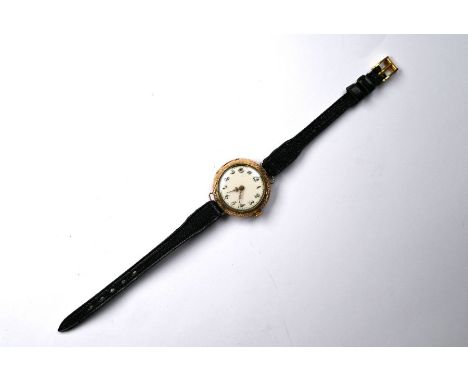 A vintage Continental lady's gilt metal wristwatch, the engraved case with floral enamelled back, 3 cm diam