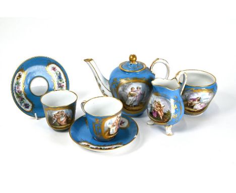 A 19th century Sevres early-morning tea set, the reserves painted with Watteauesque courting couples on a bleu ciel and gilt 