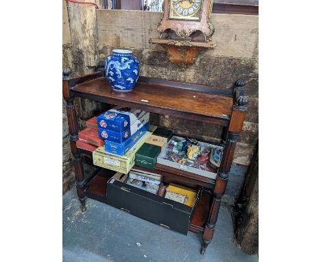 An early Victorian mahogany three tier buffet with moulded supports on ceramic castors 104cm x 44cm x 110cm h