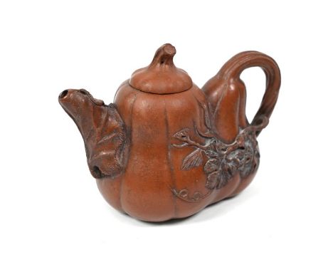 A Chinese naturalistic Yixing teapot and cover, the body in the form of two conjoined gourds with their stems forming the cov