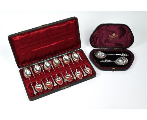A Victorian cased set of twelve coffee spoons with lion-mask finials and twist stems (possibly American), to/w a cased caddy 