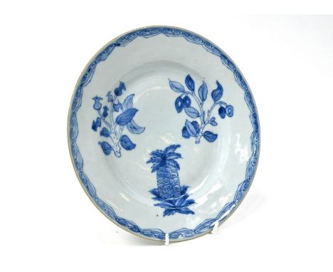 A late 18th/19th century Chinese blue and white plate, painted in underglaze blue with a large pineapple below a branch of cl