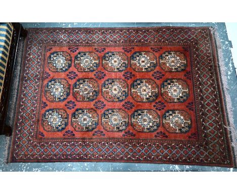 An old Afghan Messi carpet, the soft red-brown ground with three rows of guls, 293 cm x 198 cm