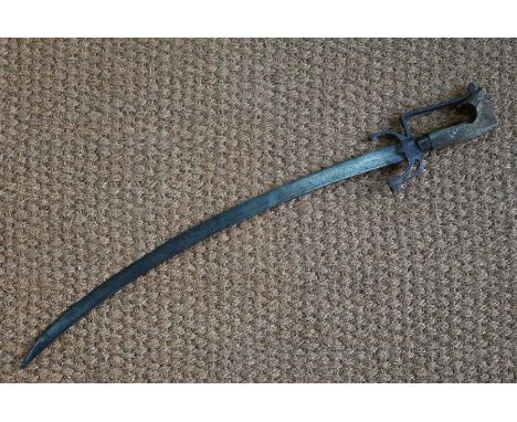 An antique scimitar - probably Indo-Persian, the 66 cm curved blade with engraved inscription, 'crab' hilt and shaped wooden 