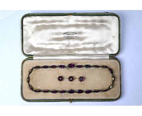 A Victorian amethyst rivière necklace, formed of twenty four foil-backed oval faceted amethysts in gilt metal setting, 40 cm 