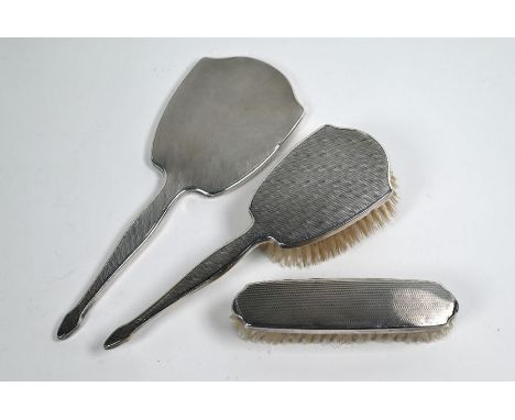 An engine-turned silver three-piece brush/mirror set (3), Adie Bros Ltd., Birmingham 1947&nbsp;