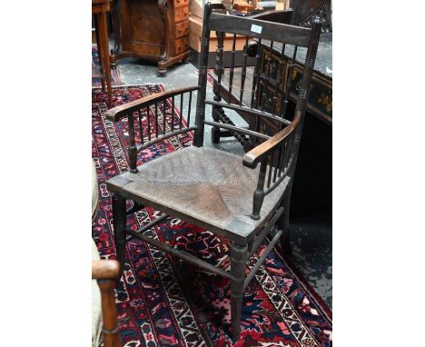 An Arts &amp; Crafts spindle back rope seat Sussex chair, 19th century, bears tin retailers plate to underside for Heal &amp;