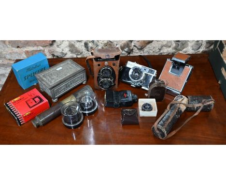 A Voigtlander 'Superb' Compur twin-lens reflex camera, a Ricoh Super Shot camera, Polaroid SX-70 Land Camera, various photogr