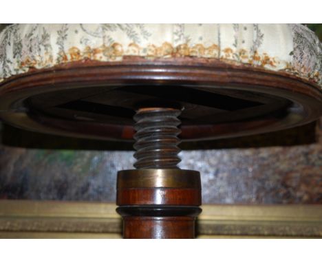 A William VI rosewood piano stool, the overstuffed revolving seat over and tripod sabre leg base