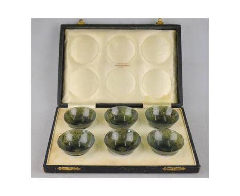 A set of six Chinese spinach jade small bowls, 6 cm diam, in fitted presentation box from H. Simmons, 60 & 61 Burlington Arca